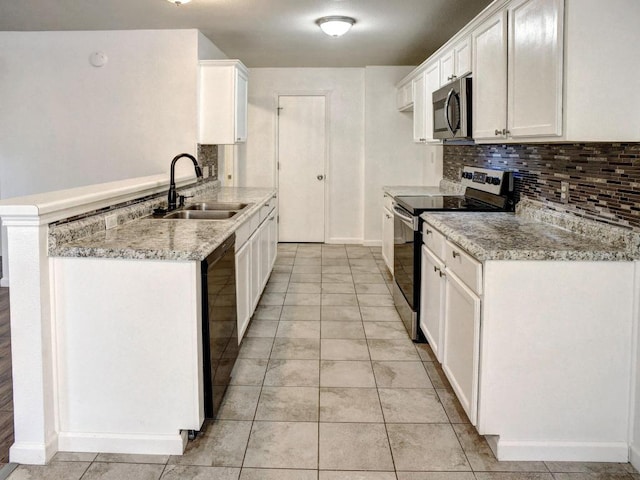 117 High Point Blvd, Cedar Creek, TX 78612 - kitchen with appliances with stainless steel finishes, backsplash, white cabinetry, a peninsula, and light tile patterned flooring