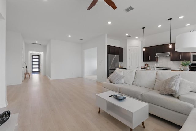 20240 Smedley Dr, Pflugerville, TX 78660 - living room featuring a ceiling fan, recessed lighting, and light wood-type flooring