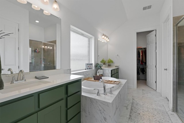 20240 Smedley Dr, Pflugerville, TX 78660 - bathroom featuring a stall shower, vanity, a bath, marble finish floors, and a walk in closet