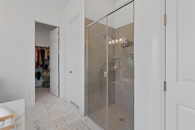 20240 Smedley Dr, Pflugerville, TX 78660 - full bathroom featuring a shower stall, marble look tile flooring, and a spacious closet