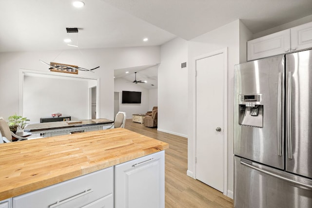 15002 Wells Port Dr, Austin, TX 78728 - kitchen featuring stainless steel fridge with ice dispenser, lofted ceiling, white cabinetry, light wood finished floors, and butcher block countertops