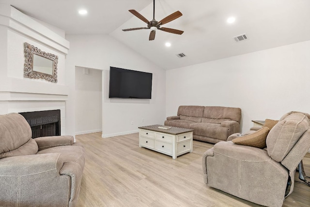 15002 Wells Port Dr, Austin, TX 78728 - living room featuring ceiling fan, a fireplace, light wood-type flooring, vaulted ceiling, and recessed lighting