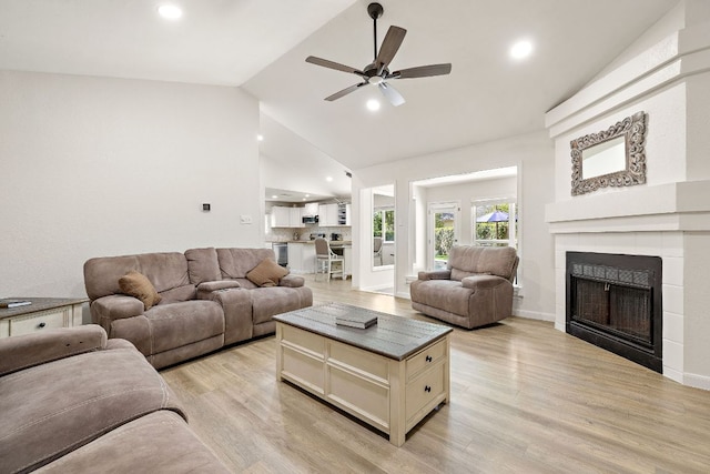 15002 Wells Port Dr, Austin, TX 78728 - living room with ceiling fan, light wood finished floors, a tiled fireplace, high vaulted ceiling, and recessed lighting