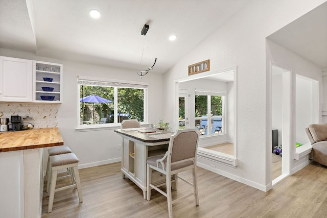 15002 Wells Port Dr, Austin, TX 78728 - dining area with light wood-type flooring, lofted ceiling, and recessed lighting