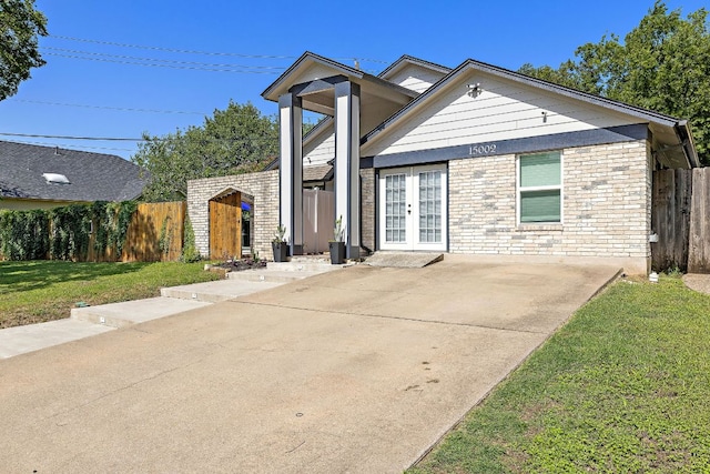 15002 Wells Port Dr, Austin, TX 78728 - view of front facade with french doors and a patio area