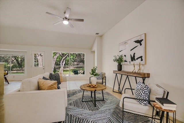 3413 Latimer Dr, Austin, TX 78732 - living area with lofted ceiling, a ceiling fan, and a textured ceiling