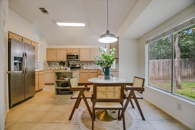 3413 Latimer Dr, Austin, TX 78732 - dining space with light tile patterned flooring and vaulted ceiling