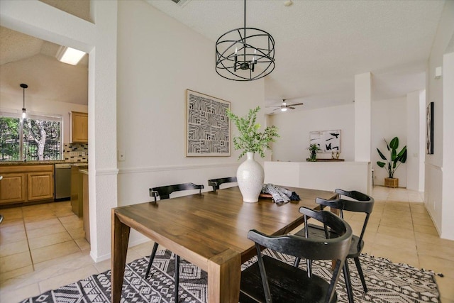 3413 Latimer Dr, Austin, TX 78732 - dining room with light tile patterned flooring, a ceiling fan, vaulted ceiling, a chandelier, and a textured ceiling