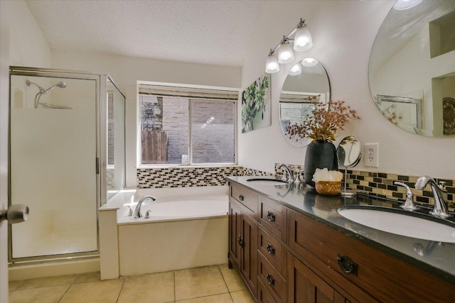 3413 Latimer Dr, Austin, TX 78732 - bathroom with a shower stall, double vanity, a bath, tile patterned flooring, and a textured ceiling