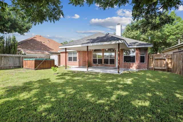 17003 Jigsaw Pathway, Round Rock, TX 78664 - back of property with a patio area, brick siding, and a fenced backyard
