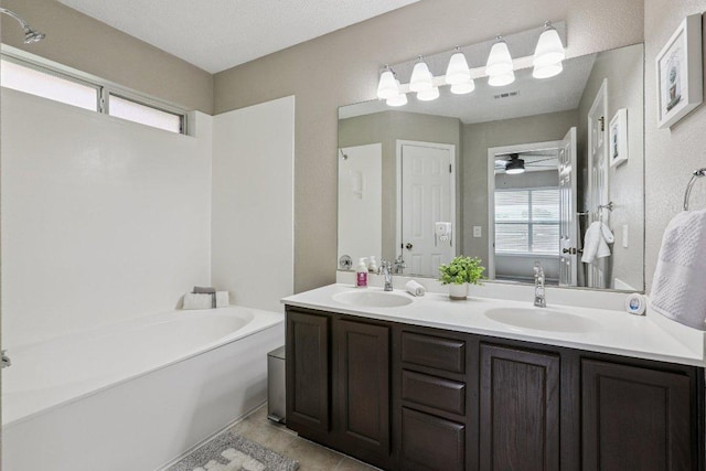 17003 Jigsaw Pathway, Round Rock, TX 78664 - full bath featuring double vanity, a bath, ceiling fan, and tile patterned flooring