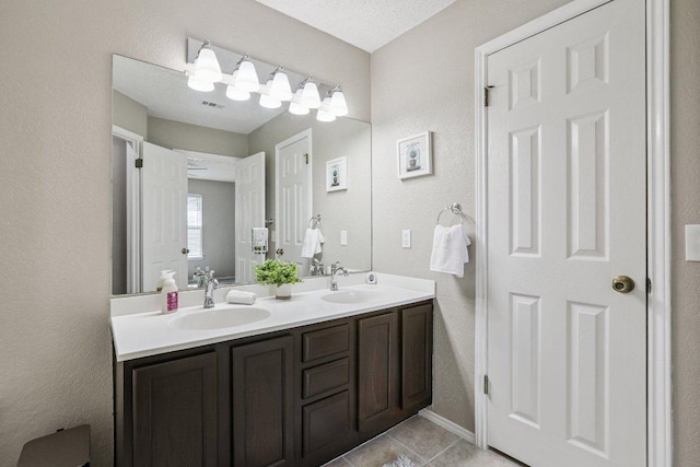 17003 Jigsaw Pathway, Round Rock, TX 78664 - bathroom with double vanity and tile patterned flooring