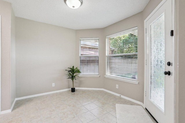 17003 Jigsaw Pathway, Round Rock, TX 78664 - unfurnished room with a textured ceiling and light tile patterned floors