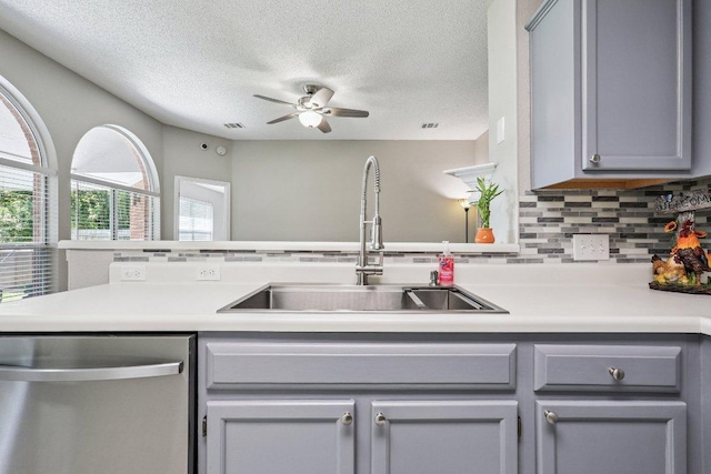17003 Jigsaw Pathway, Round Rock, TX 78664 - kitchen with stainless steel dishwasher, gray cabinetry, a ceiling fan, light countertops, and a textured ceiling