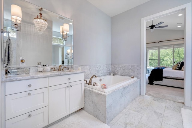 3973 River Place Blvd, Austin, TX 78730 - ensuite bathroom featuring vanity, a ceiling fan, a garden tub, marble finish floors, and a chandelier