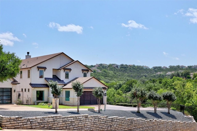 3973 River Place Blvd, Austin, TX 78730 - view of front of home featuring concrete driveway, a standing seam roof, an attached garage, and a metal roof