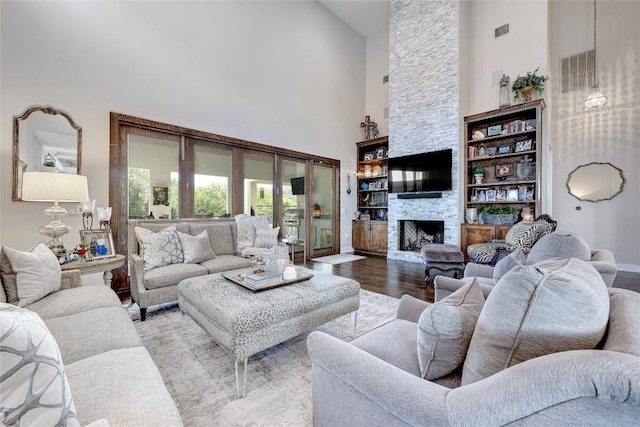 3973 River Place Blvd, Austin, TX 78730 - living room with high vaulted ceiling, wood finished floors, and a stone fireplace