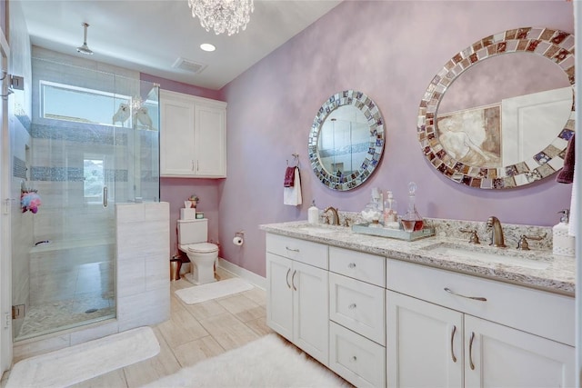 3973 River Place Blvd, Austin, TX 78730 - bathroom featuring double vanity, a shower stall, and a chandelier