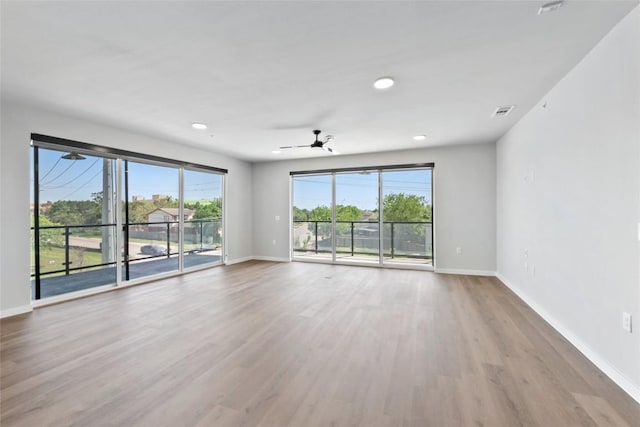 4510 Terry-O Ln Unit 230, Austin, TX 78745 - empty room with healthy amount of natural light, wood finished floors, a ceiling fan, and recessed lighting