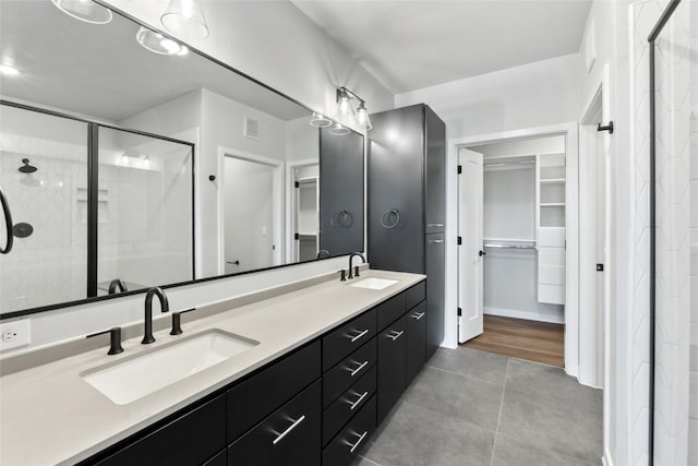 4510 Terry-O Ln Unit 230, Austin, TX 78745 - bathroom with a spacious closet, a stall shower, double vanity, and tile patterned flooring
