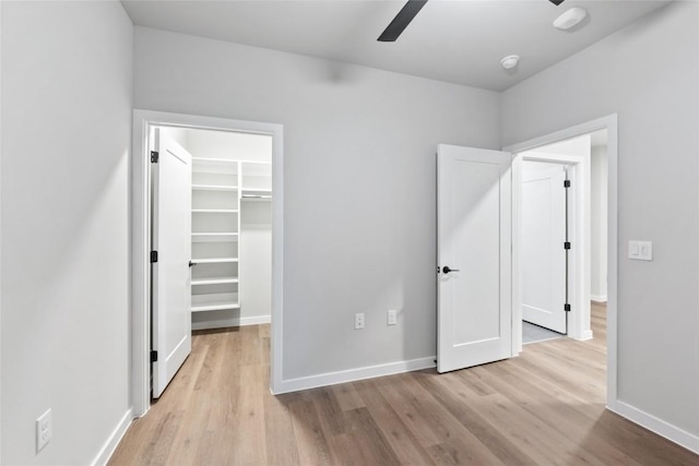 4510 Terry-O Ln Unit 230, Austin, TX 78745 - unfurnished bedroom featuring a walk in closet, wood finished floors, and a ceiling fan