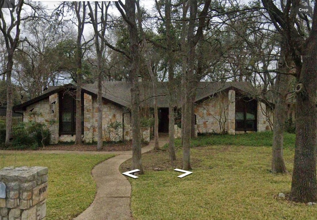 9107 Cedar Crest Dr, Austin, TX 78750 - mid-century inspired home with stone siding and a front yard