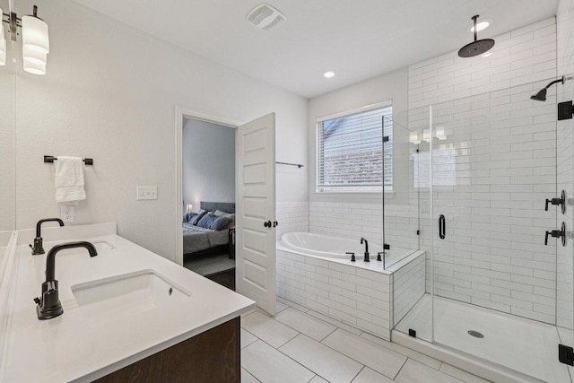 958 Pink Granite Blvd, Dripping Springs, TX 78620 - ensuite bathroom featuring double vanity, a stall shower, a garden tub, tile patterned flooring, and recessed lighting