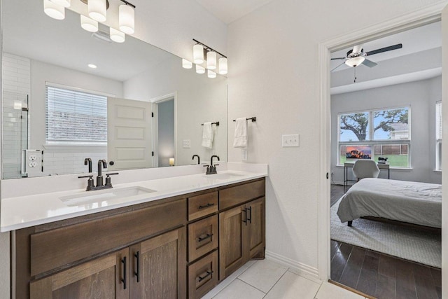 958 Pink Granite Blvd, Dripping Springs, TX 78620 - full bath with double vanity, a ceiling fan, connected bathroom, and tile patterned flooring