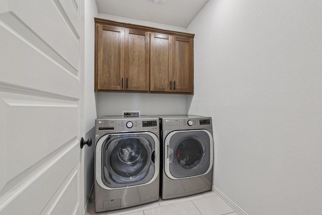 958 Pink Granite Blvd, Dripping Springs, TX 78620 - washroom with cabinet space, washing machine and clothes dryer, and light tile patterned flooring