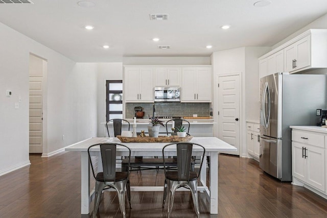 958 Pink Granite Blvd, Dripping Springs, TX 78620 - kitchen with appliances with stainless steel finishes, dark wood-style floors, tasteful backsplash, recessed lighting, and white cabinets