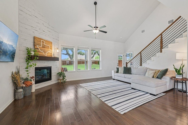 958 Pink Granite Blvd, Dripping Springs, TX 78620 - living room featuring high vaulted ceiling, stairs, a ceiling fan, a fireplace, and wood finished floors