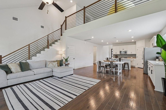 958 Pink Granite Blvd, Dripping Springs, TX 78620 - living room featuring stairs, a ceiling fan, dark wood finished floors, a towering ceiling, and recessed lighting