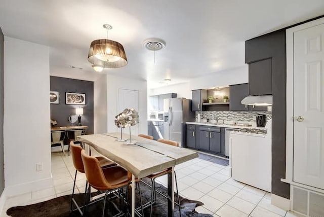 313 Rowland Dr, Austin, TX 78745 - dining area featuring light tile patterned floors and baseboards