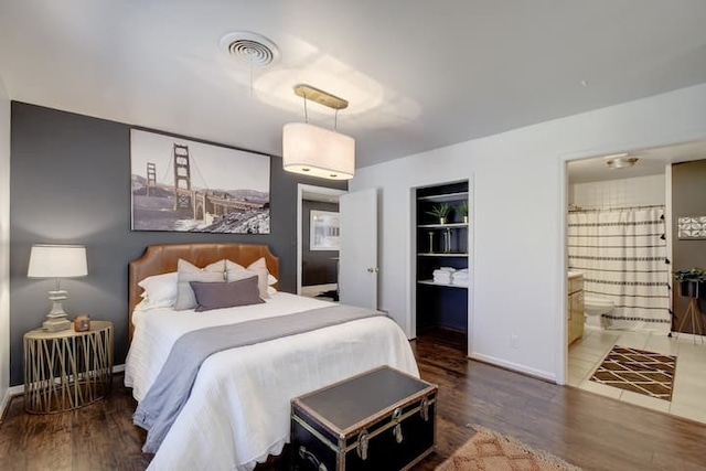 313 Rowland Dr, Austin, TX 78745 - bedroom with wood finished floors and ensuite bathroom