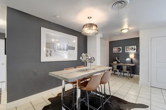 313 Rowland Dr, Austin, TX 78745 - dining area with light tile patterned floors and baseboards
