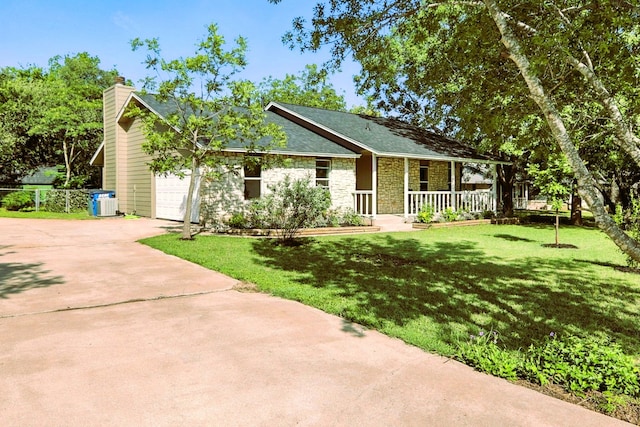 2207 Emerald Isle Dr, Leander, TX 78641 - single story home featuring covered porch, concrete driveway, stone siding, a front yard, and a chimney
