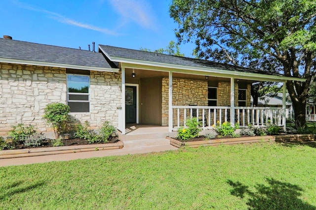 2207 Emerald Isle Dr, Leander, TX 78641 - view of front of house with stone siding, a front lawn, and covered porch