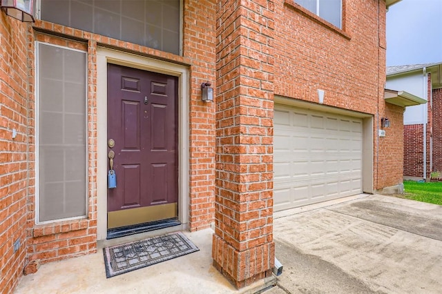 6050 Almelo Dr, Round Rock, TX 78681 - view of exterior entry featuring brick siding, an attached garage, and driveway
