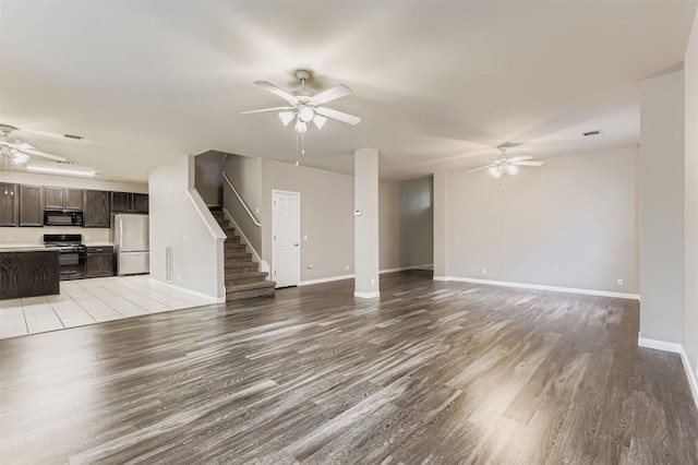 6050 Almelo Dr, Round Rock, TX 78681 - unfurnished living room with a ceiling fan, light wood-style flooring, and stairs