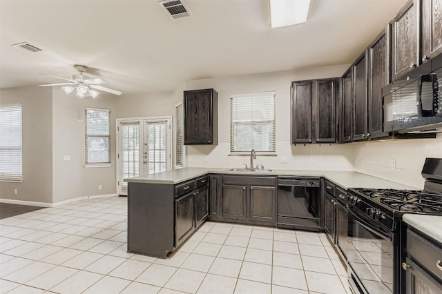 6050 Almelo Dr, Round Rock, TX 78681 - kitchen with black appliances, a peninsula, ceiling fan, dark brown cabinets, and light tile patterned floors