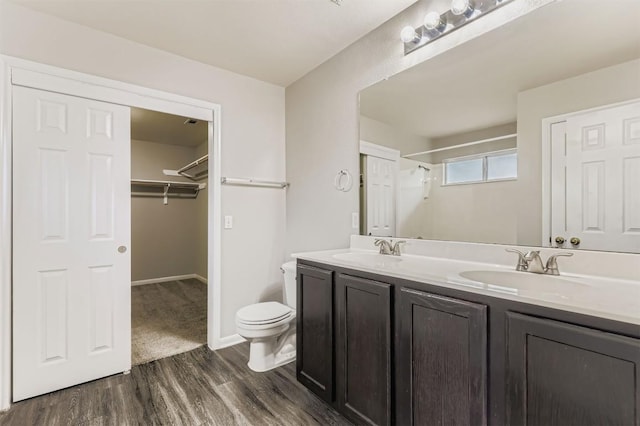 6050 Almelo Dr, Round Rock, TX 78681 - full bathroom with wood finished floors, double vanity, a spacious closet, and a shower