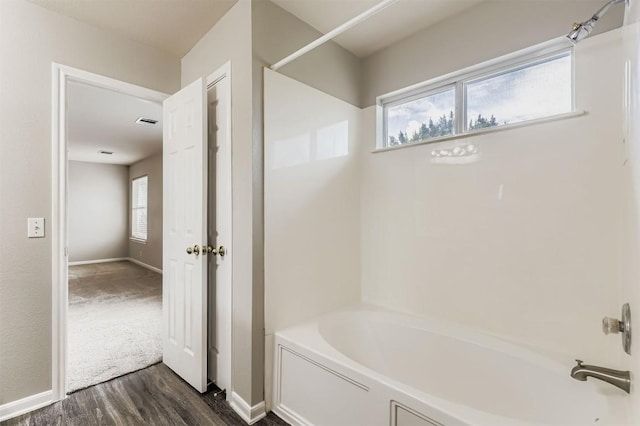 6050 Almelo Dr, Round Rock, TX 78681 - bathroom featuring a tub to relax in, wood finished floors, and a shower