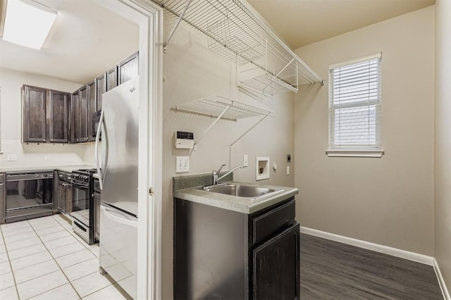 6050 Almelo Dr, Round Rock, TX 78681 - washroom with hookup for a washing machine, hookup for an electric dryer, and light wood-style floors