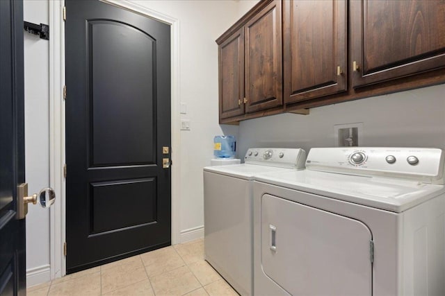 205 Versilia Cir, Lakeway, TX 78734 - laundry room featuring cabinet space, washer and clothes dryer, and light tile patterned floors