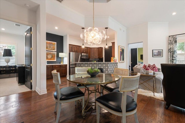205 Versilia Cir, Lakeway, TX 78734 - dining area featuring ornamental molding, dark wood finished floors, a chandelier, and recessed lighting