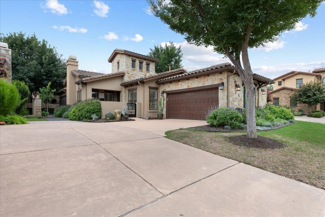 205 Versilia Cir, Lakeway, TX 78734 - mediterranean / spanish-style home featuring a garage, concrete driveway, stone siding, a chimney, and stucco siding