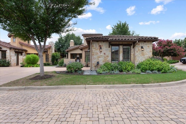 205 Versilia Cir, Lakeway, TX 78734 - mediterranean / spanish-style house with stone siding, concrete driveway, a tile roof, and stucco siding