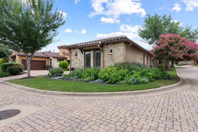 205 Versilia Cir, Lakeway, TX 78734 - view of front of house featuring stone siding, decorative driveway, stucco siding, and a tile roof