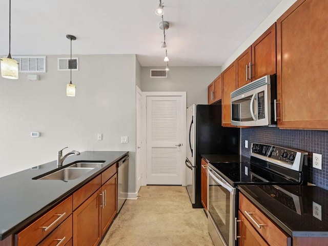3016 Guadalupe St Unit 211, Austin, TX 78705 - kitchen featuring stainless steel appliances, dark countertops, tasteful backsplash, brown cabinetry, and decorative light fixtures
