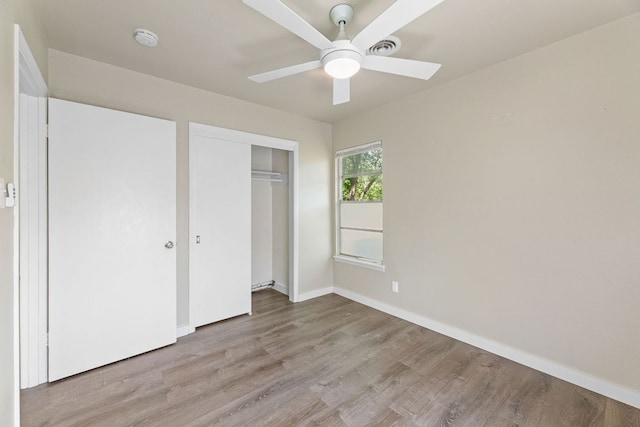 5302 Robinsdale Ln, Austin, TX 78723 - unfurnished bedroom with wood finished floors, a closet, and ceiling fan